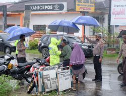 Cuaca Hujan, Kapolres Tanjung Balai Bersama Personil Payungin Warga Vaksin di Polres Tanjung Balai